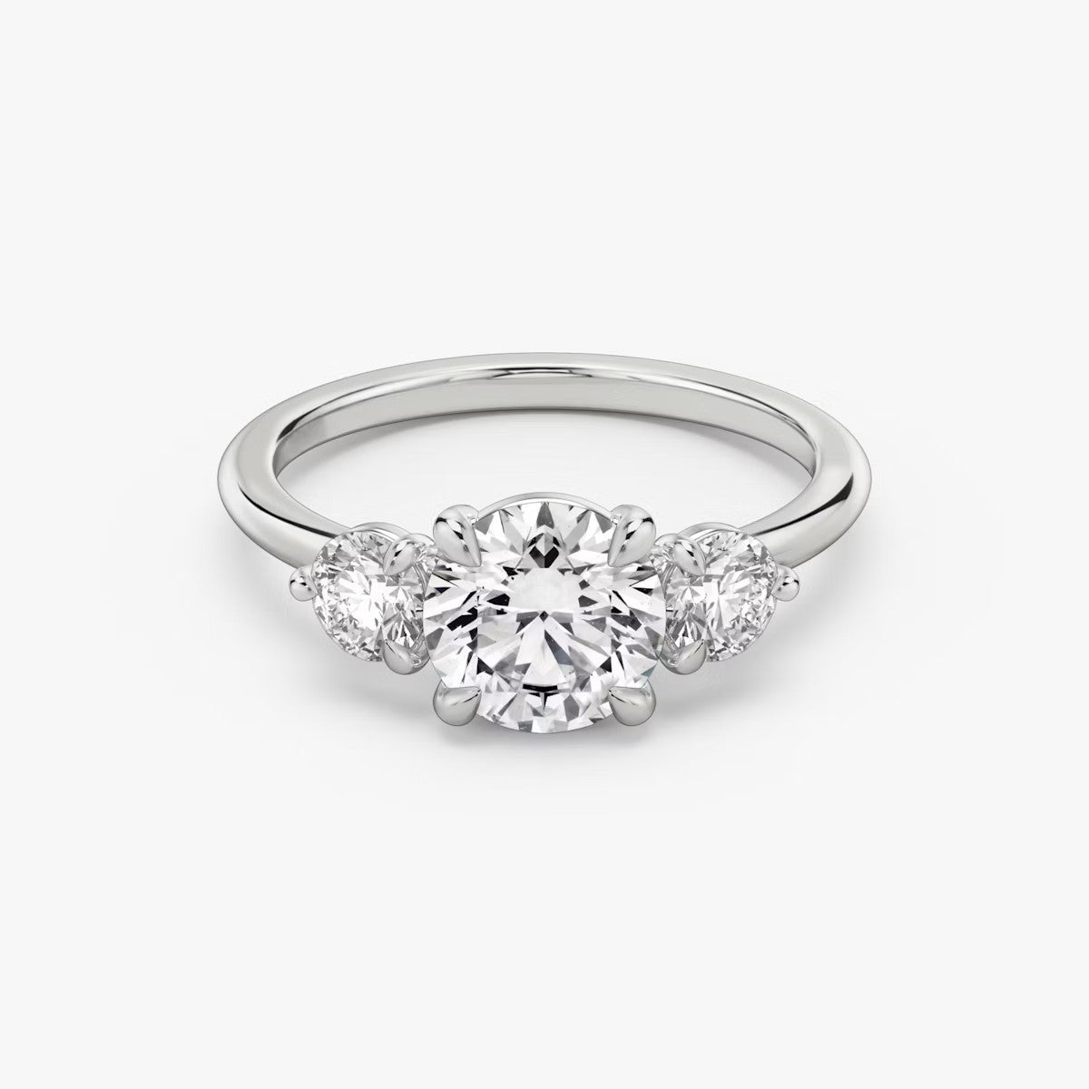 The Three Stone Round Brilliant with Round Side Stones Engagement Ring