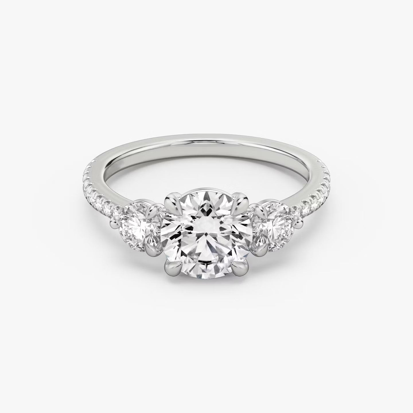 The Three Stone Round Brilliant with Round Side Stones Pave Engagement Ring