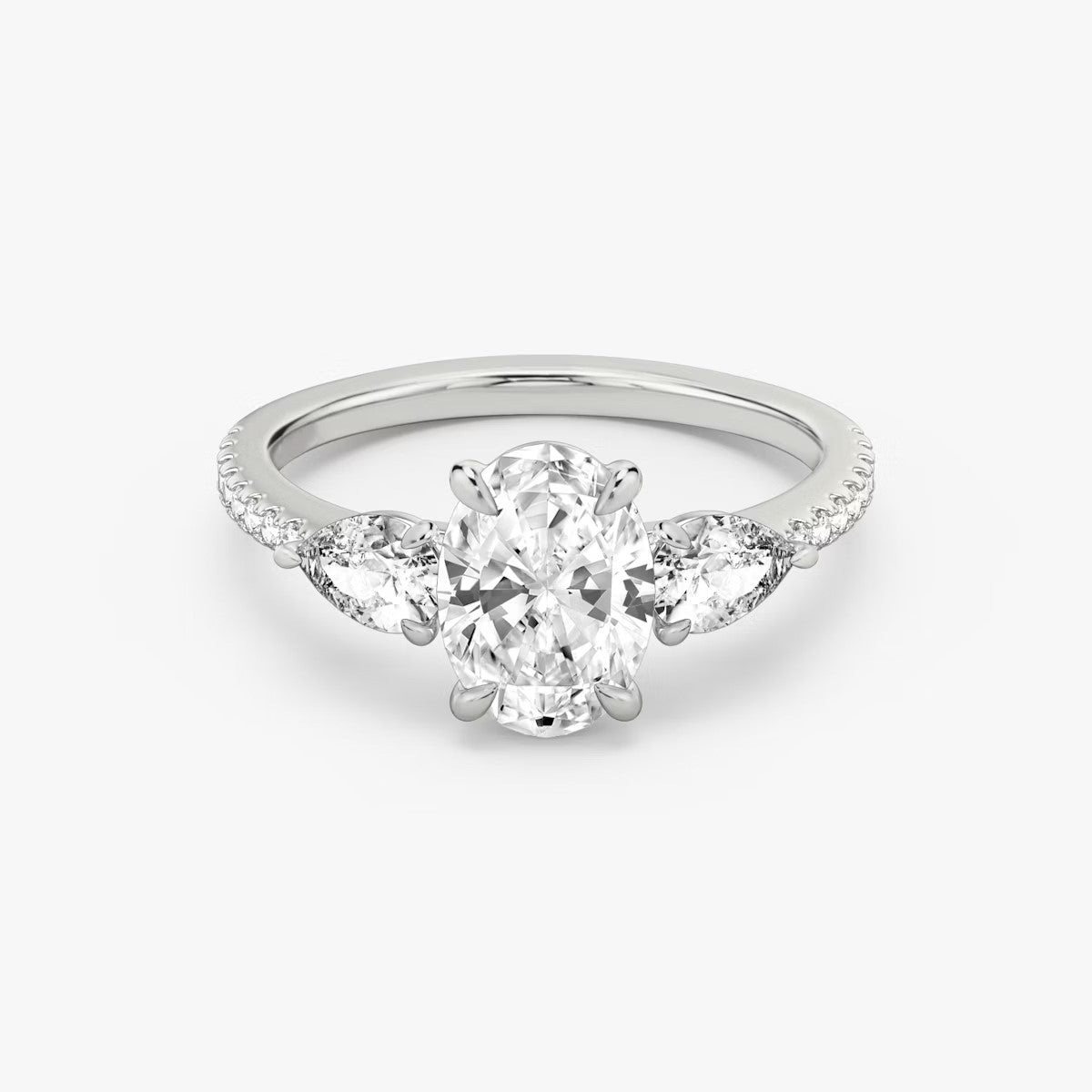 The Three Stone Oval with Pear Side Stones Pave Engagement Ring