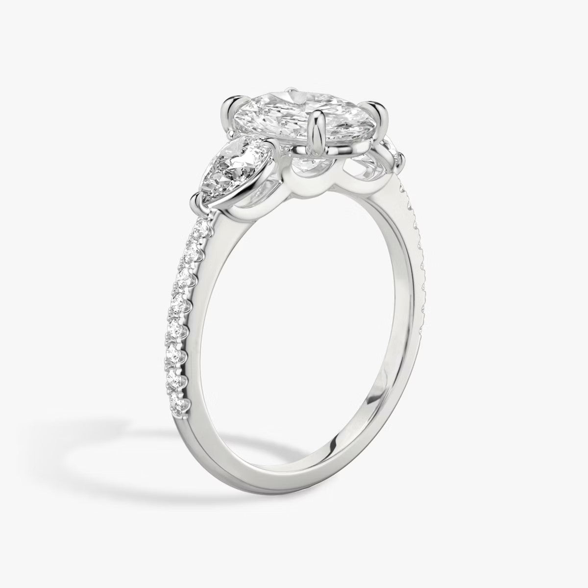 The Three Stone Oval with Pear Side Stones Pave Engagement Ring