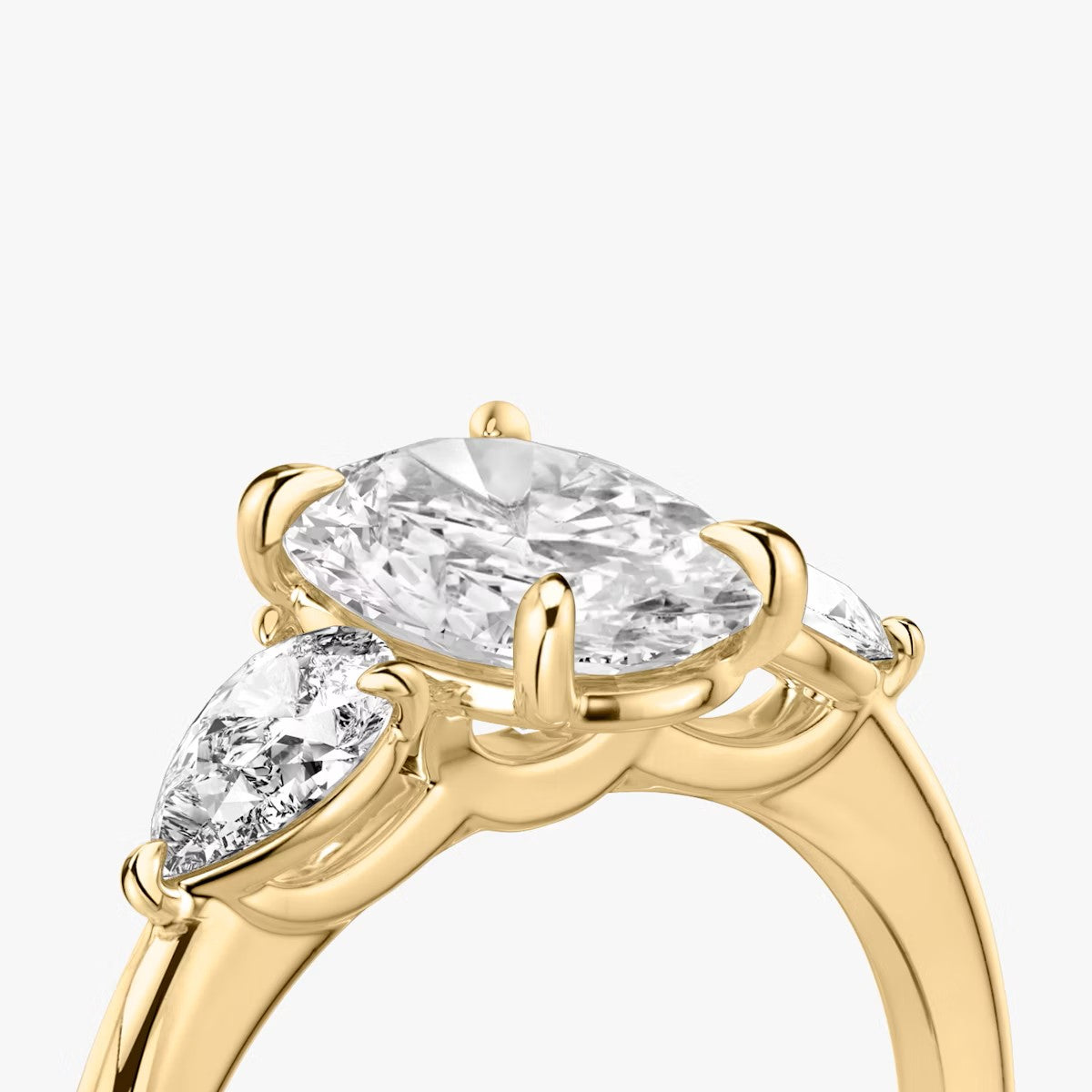 The Three Stone Oval with Pear side stones Engagement Ring