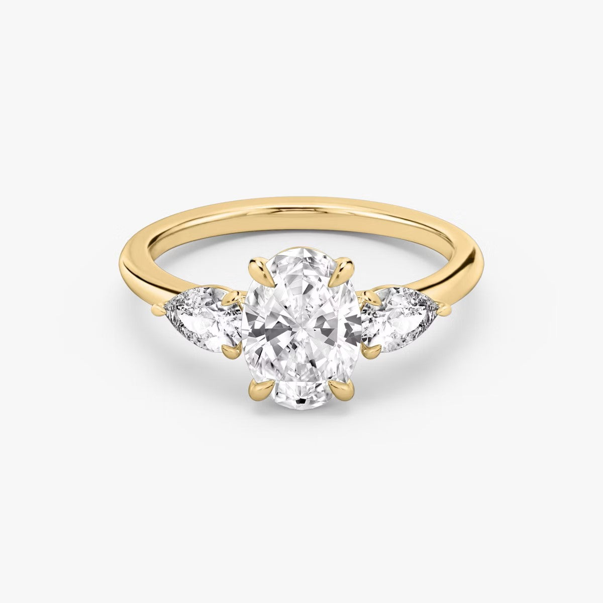 The Three Stone Oval with Pear side stones Engagement Ring