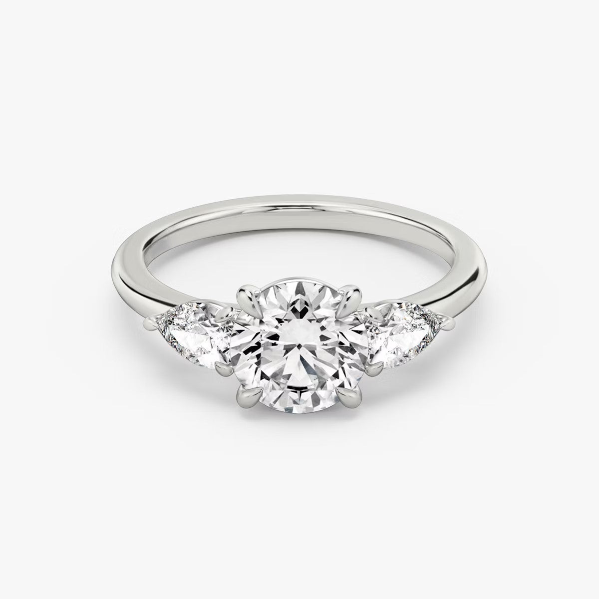 The Three Stone Round Brilliant With Pear Side Stones Engagement Ring