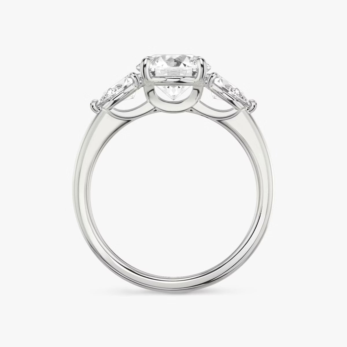 The Three Stone Round Brilliant With Pear Side Stones Engagement Ring