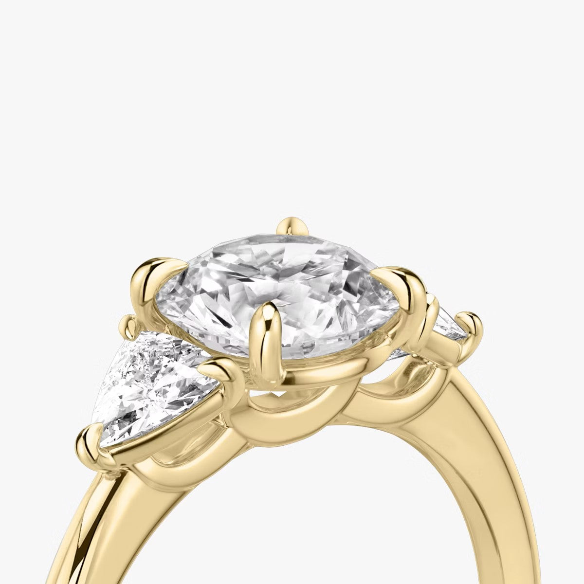 The Three Stone Round Brilliant with Trillion Side Stones Engagement Ring