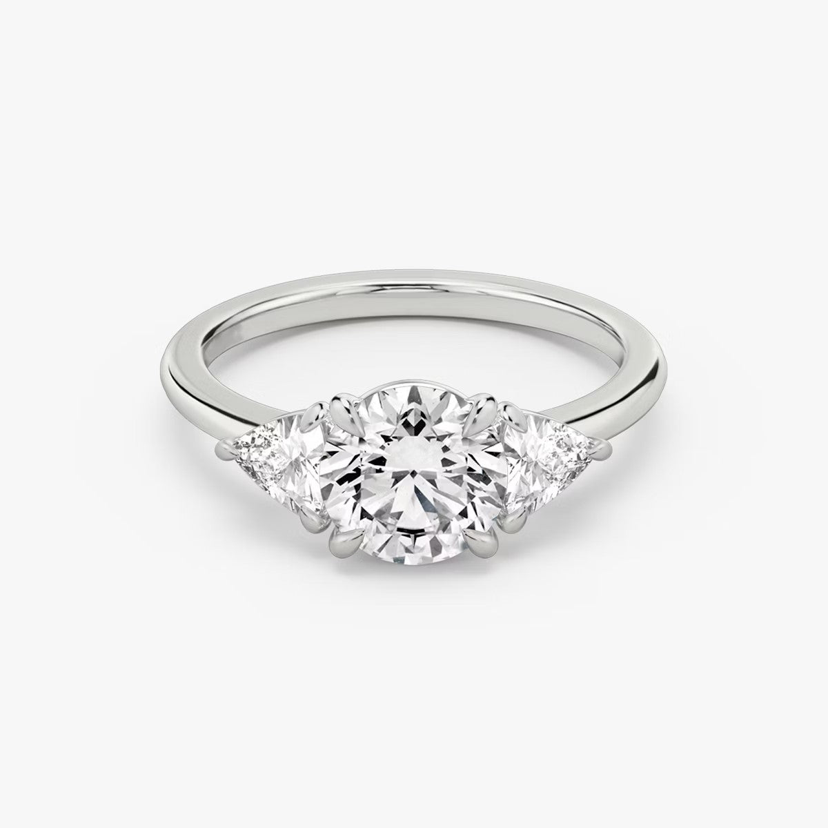 The Three Stone Round Brilliant with Trillion Side Stones Engagement Ring