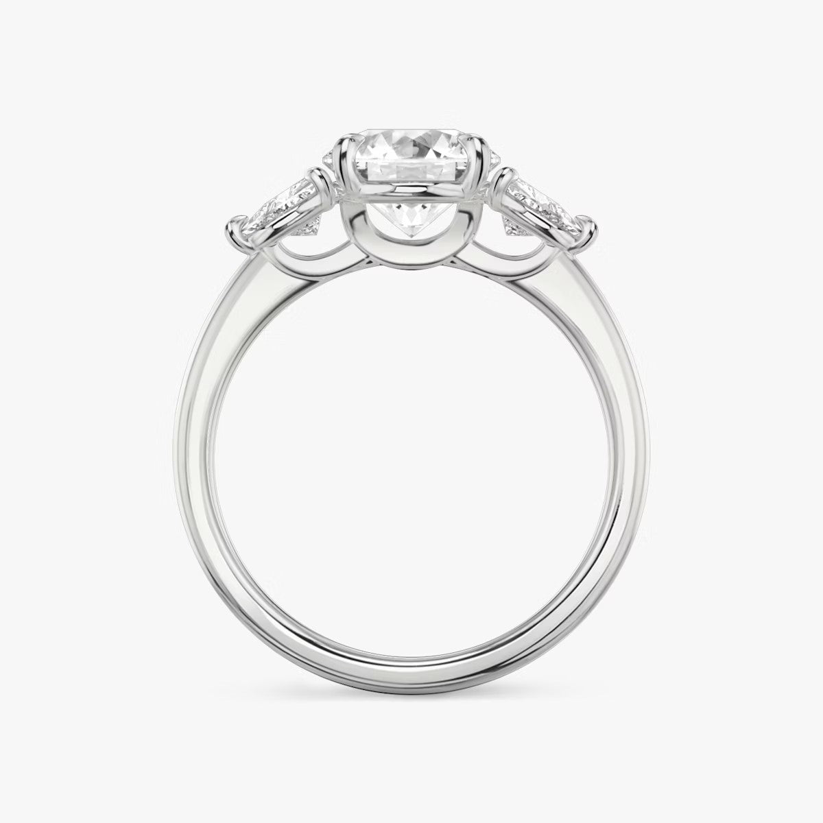 The Three Stone Round Brilliant with Trillion Side Stones Engagement Ring