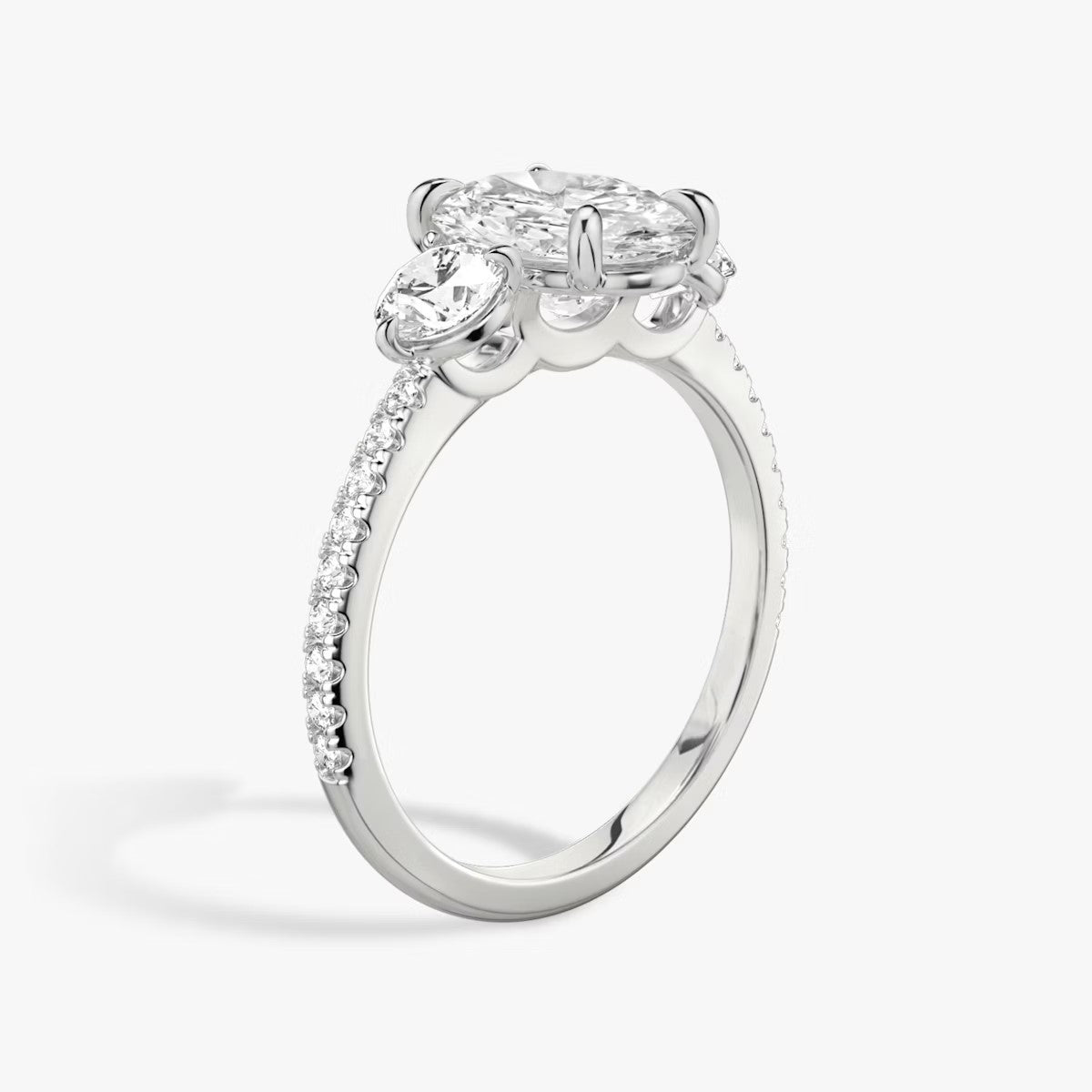 The Three Stone Oval with Round Side Stones Pave Engagement Ring