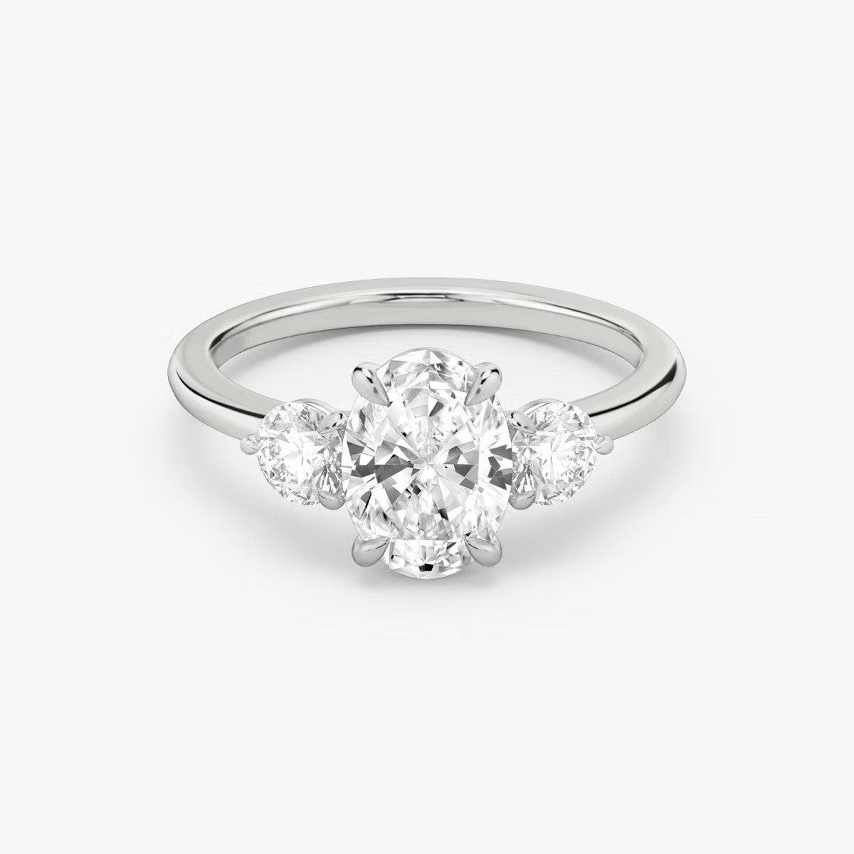 The Three Stone Oval with Round side stones Engagement Ring