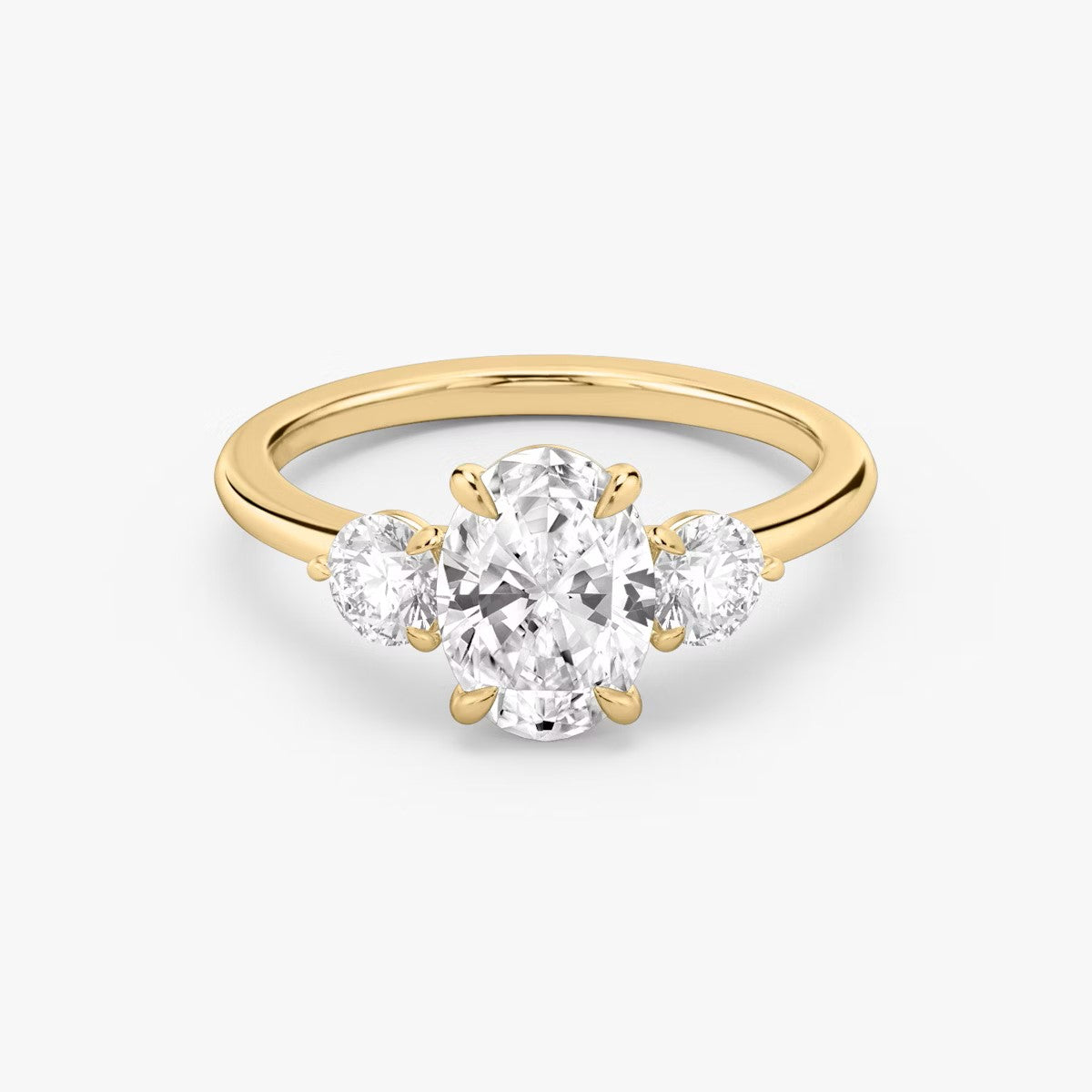 The Three Stone Oval with Round side stones Engagement Ring