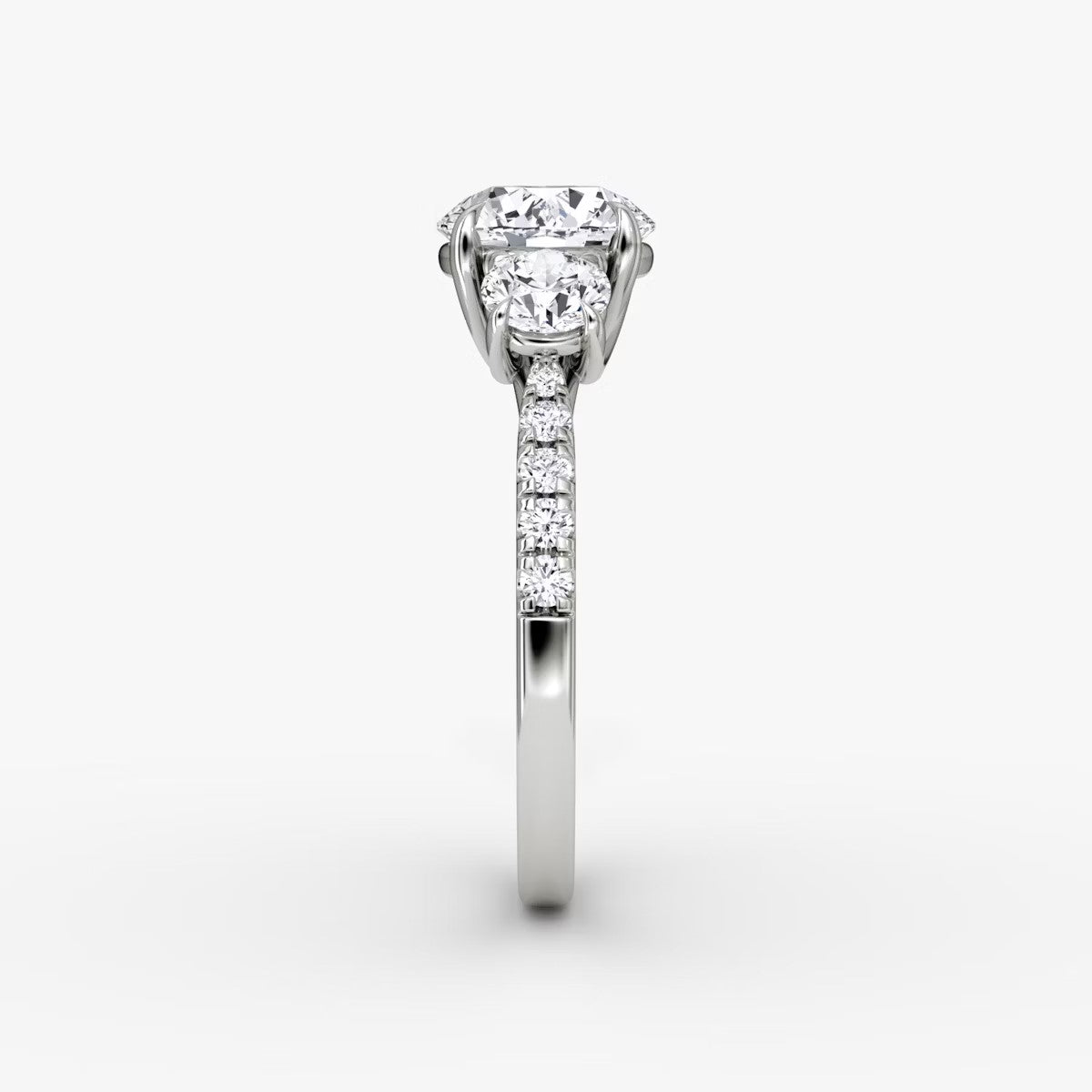 The Erelis Three Stone Round Brilliant Pave Engagement Ring