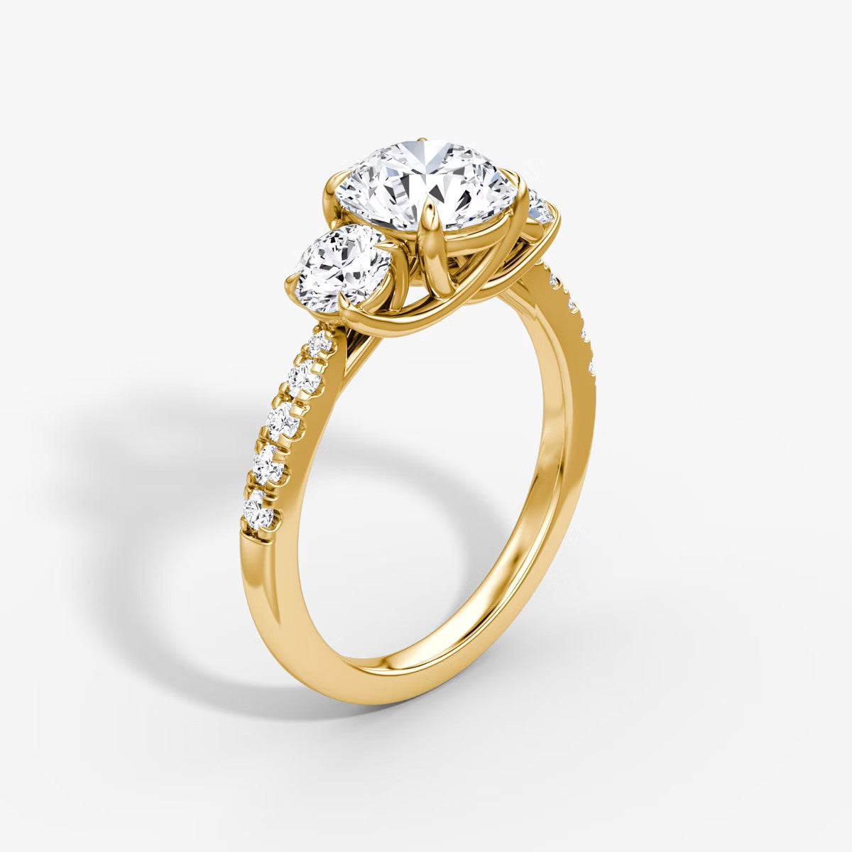 The Erelis Three Stone Round Brilliant Pave Engagement Ring